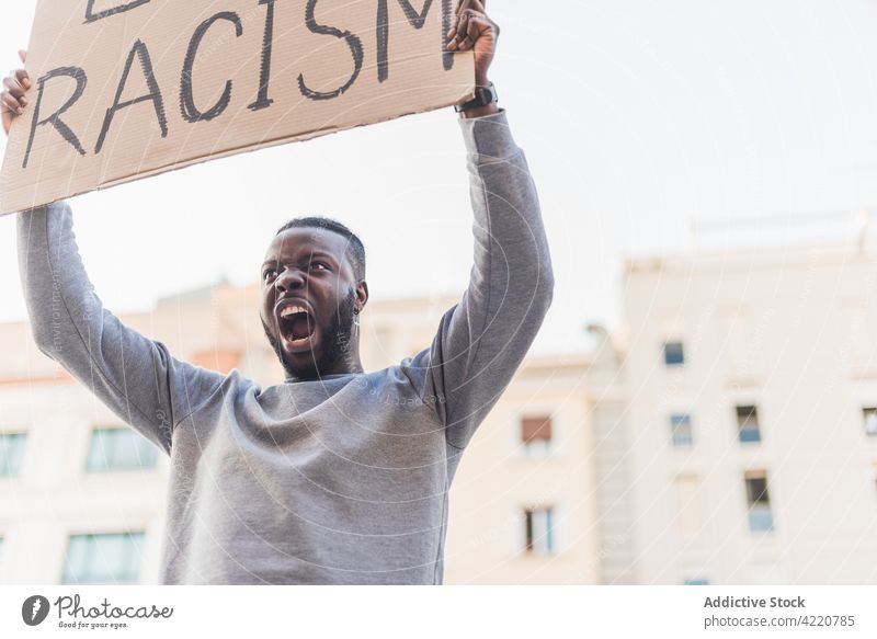 Black man protesting during Black Lives Matter demonstration black lives matter activist scream racism poster demonstrate shout protester male blm ethnic