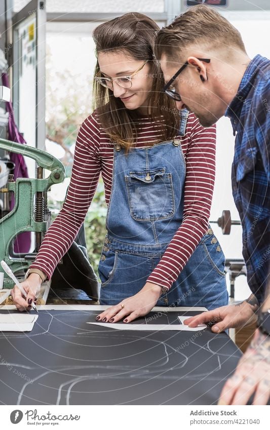 Couple of artisans working with leather in workshop mark fabric couple upholstery workbench together handmade sewer craftsman craftswoman material create