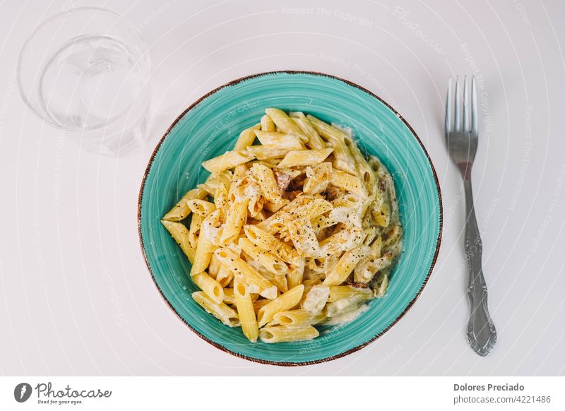 Plate of macaroni with cream sauce, onion and flax seeds. spaghetti appetizing ingredient italian food food plate tasty food nutrition kitchen table culinary