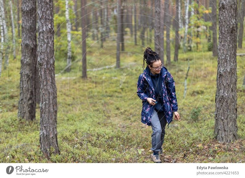 Woman picking mushroom in the forest mushrooms food fresh fungus healthy plants trees Poland day outdoors daytime nature autumn fall wild green wilderness