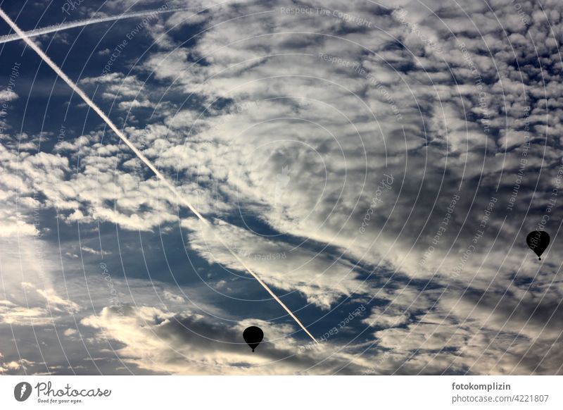 two hot air balloons in the cloudy sky hot-air balloon hot air balloon ride Vapor trail Clouds Sky Flying Aviation Freedom Far-off places Wanderlust Floating