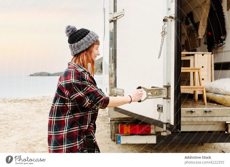 Traveling woman opening van at lakeside travel door hipster traveler truck shore female mountain adventure vacation explorer nature wanderlust trip holiday