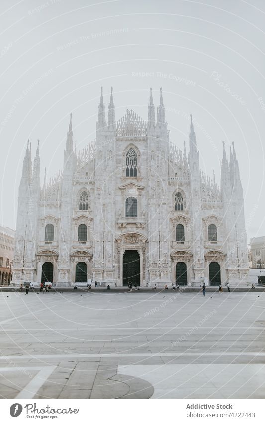 Aged cathedral with decoration in sunshine in town architecture reflection sacred religion catholic magnificent city duomo facade majestic sunbeam urban