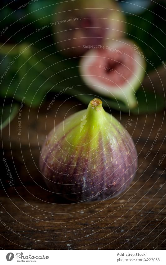 Ripe fig on brown background fruit ripe juicy healthy food pulp fresh vitamin natural leaf foliage organic ingredient sweet tasty product whole delicious