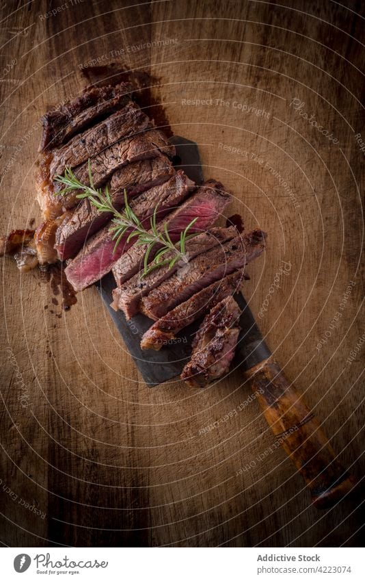 Delicious cut beef slices with fresh rosemary sprig meat lunch food dinner protein delicious cleaver appetizing aroma savory tasty juicy tender soft hatchet