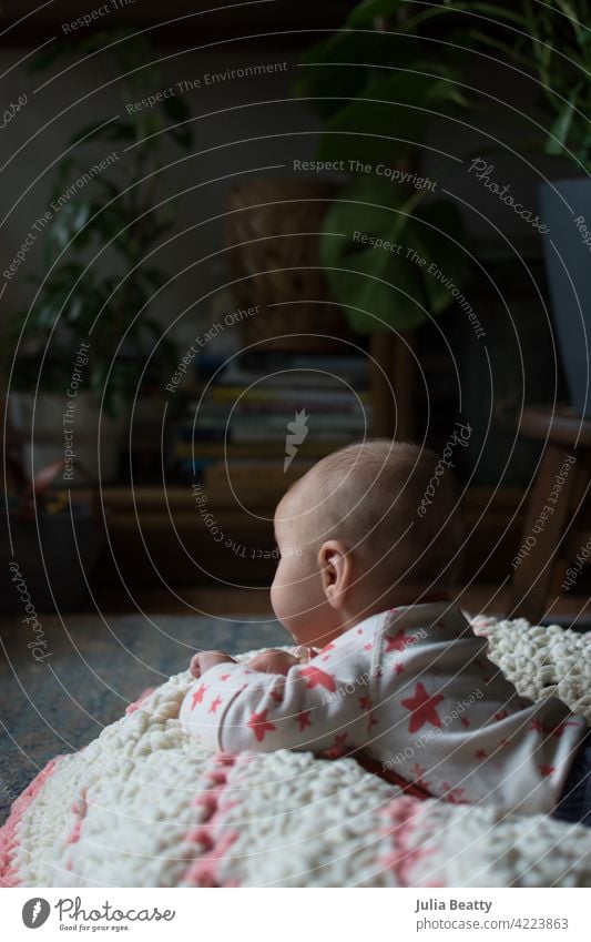 3 month old baby doing tummy time; bohemian interior room with houseplants infant 3 months old 0-6 months old floor time core strength gross motor learn