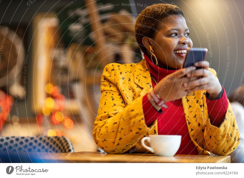 Happy young woman with smartphone in a cafe coffee restaurant coffee shop positivity confident carefree people adult casual beautiful attractive female