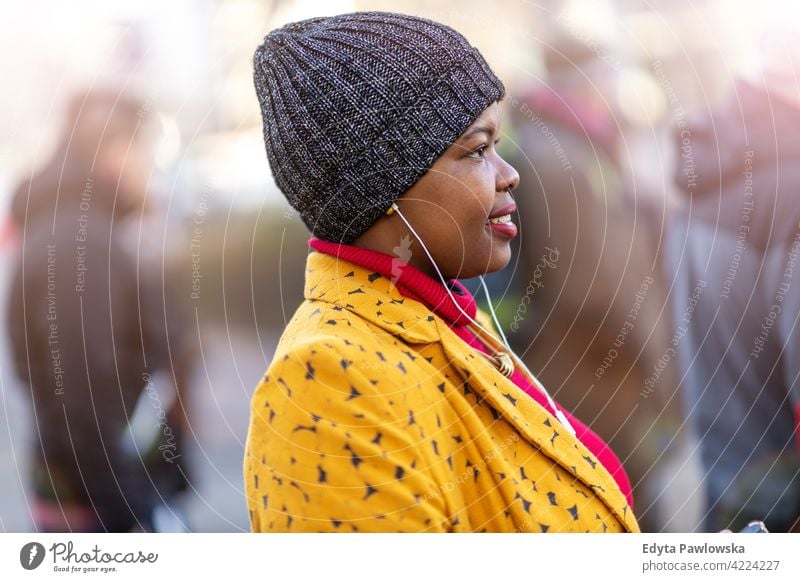 Attractive young woman standing in the crowd outdoors day positivity confident carefree people adult casual beautiful attractive female one person smiling happy