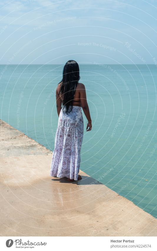 Young woman on her back enjoying the beach. Summer vacation concept summer travel sun time fun blue sea tropical black girl happy beauty skin model holiday fit