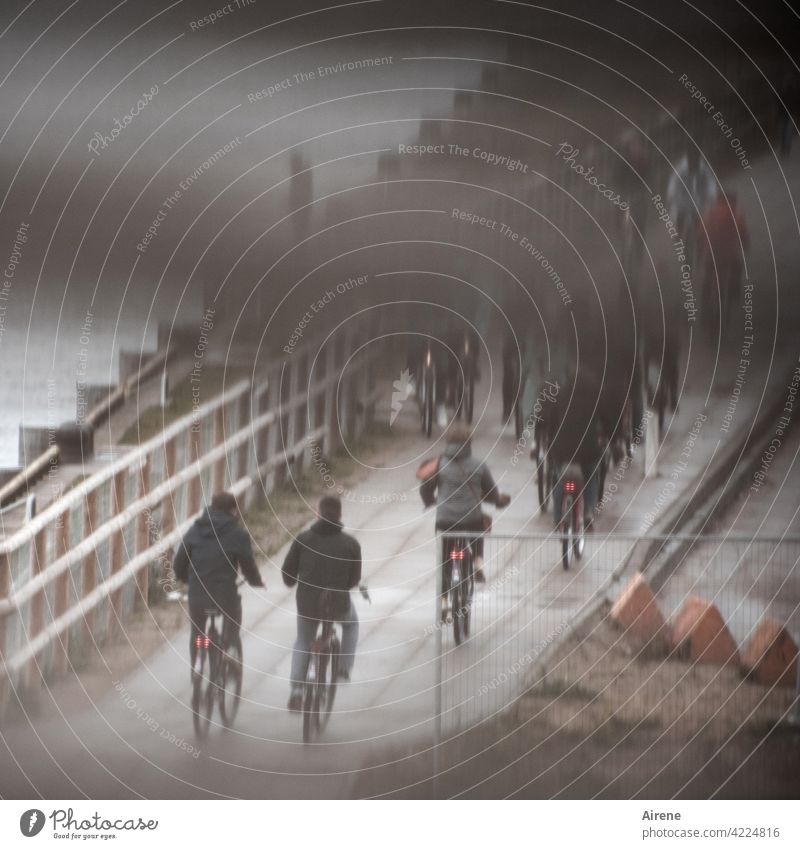 apocalyptic mood cyclists rush hour Rainy weather Dreary Traffic lane cycle path cordon Commuter Bad weather Construction site Hoarding off somber Footpath