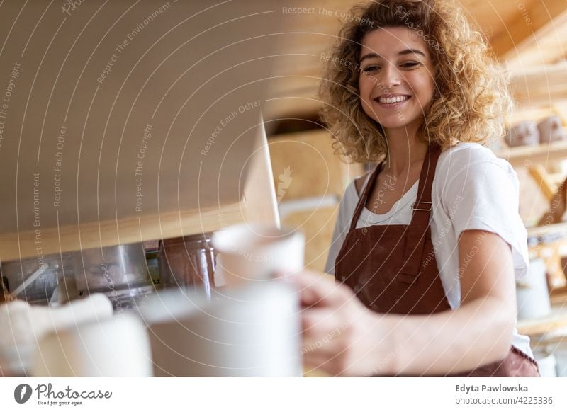 Portrait of woman pottery artist in art studio ceramics work working people young adult casual attractive female happy Caucasian enjoying one person beautiful