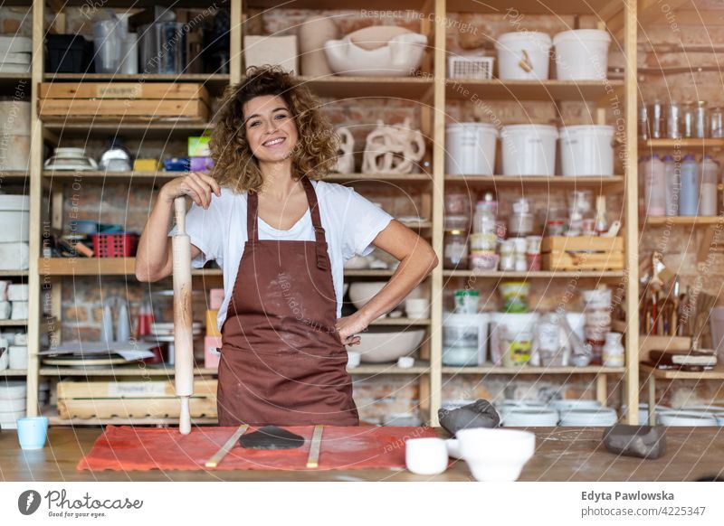 Portrait of woman pottery artist in art studio ceramics work working people young adult casual attractive female happy Caucasian enjoying one person beautiful