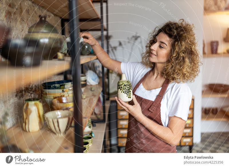 Portrait of woman pottery artist in art studio ceramics work working people young adult casual attractive female happy Caucasian enjoying one person beautiful