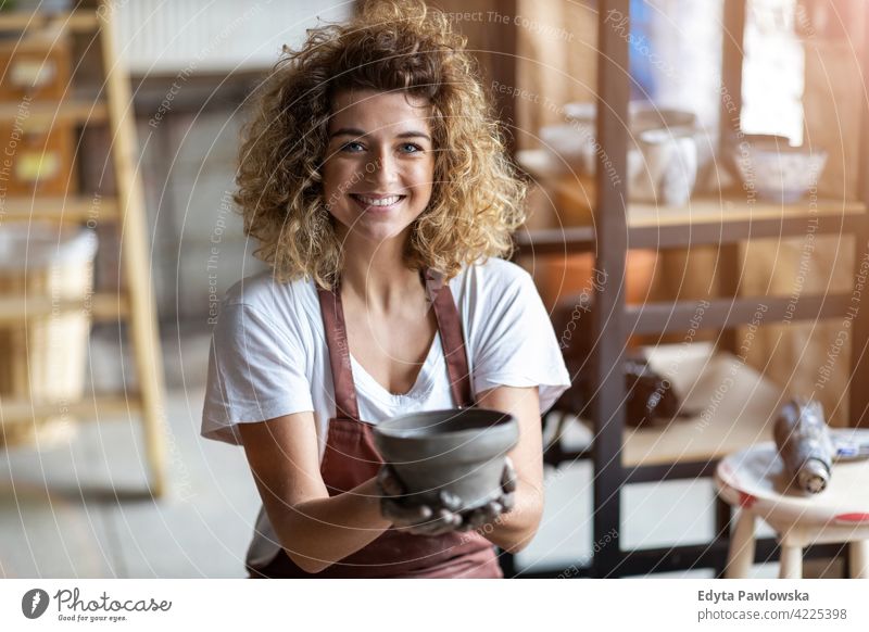 Portrait of woman pottery artist in art studio ceramics work working people young adult casual attractive female happy Caucasian enjoying one person beautiful