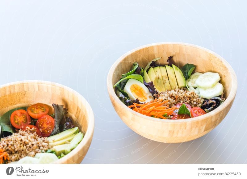 Brown rice salad with carrot, egg, cucumber, avocado, tomato and lamb's lettuce antioxidant asian background bowl brown buddha bowl copy space cuisine detox