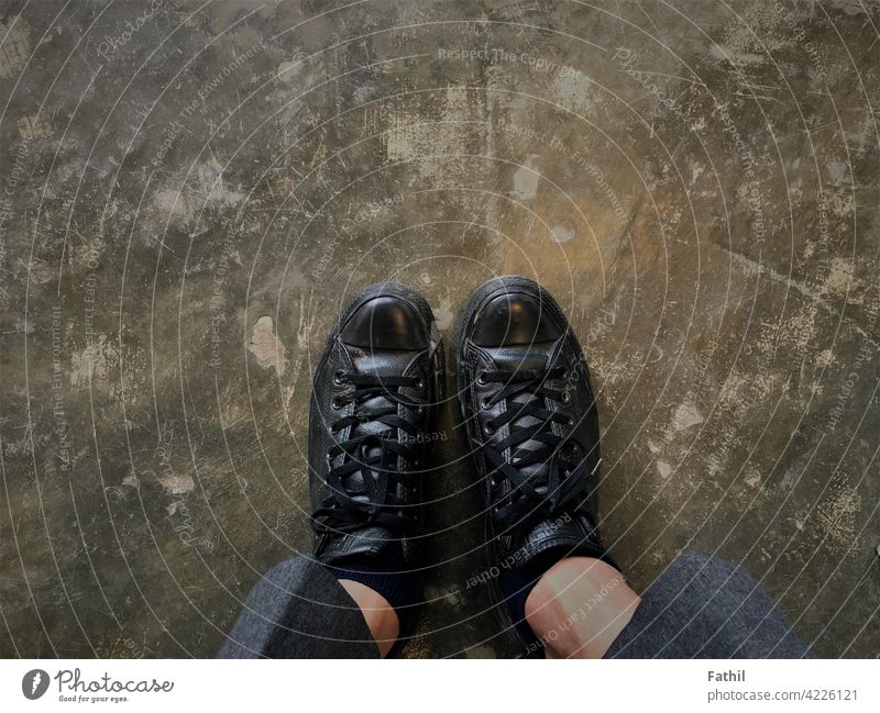 Black Shoes in the cafe on the grey floor. shoe black background Footwear feet Shoelace