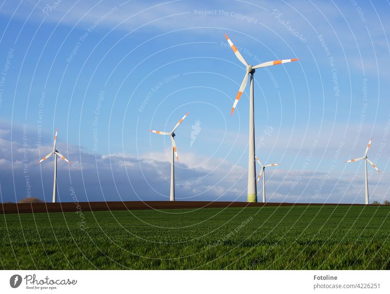 Wind energy is generated here. Wind turbines turn against a cloudy sky. Pinwheel Wind energy plant Energy Renewable energy Energy industry Electricity Sky