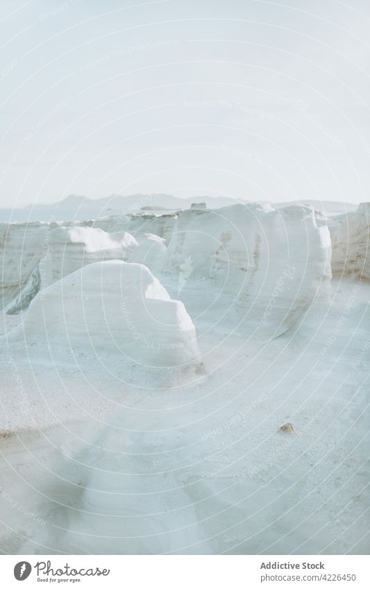 White rocky formations in sunny terrain stone nature rough spacious sunlight scenic geology highland sarakiniko milos environment blue sky white picturesque