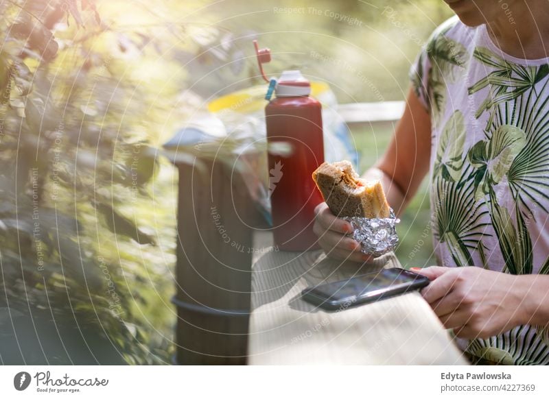 Female hiker taking brake, eating sandwich summer nature forest wild green people outdoors one person happy Caucasian wilderness plant tree Poland day