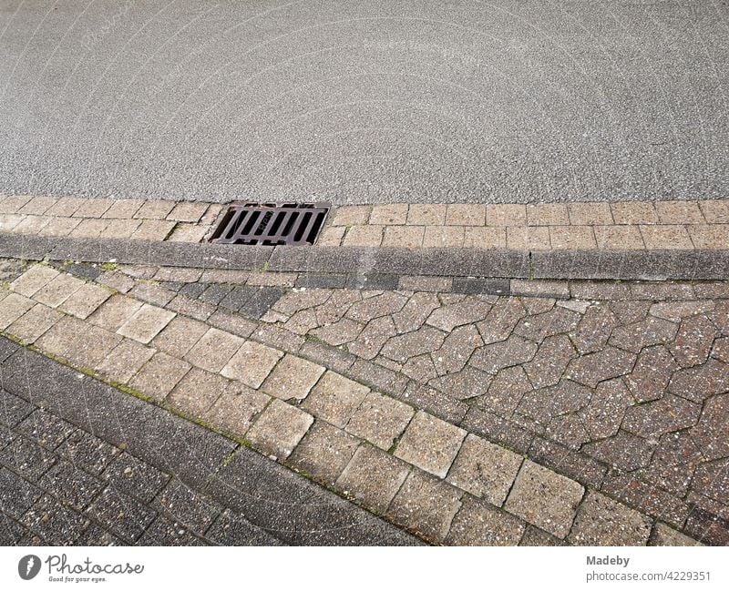 Flattened kerb with interlocking paving at a bus stop in Oerlinghausen near Bielefeld in the Teutoburg Forest in East Westphalia-Lippe pavement composite paving