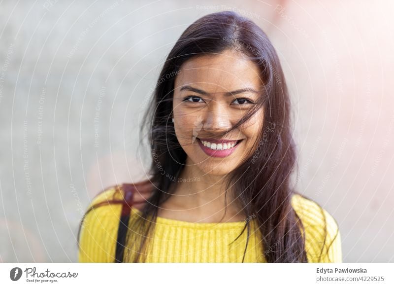 Portrait of beautiful young woman in urban area Filipino street city active people young adult casual attractive female happy asian enjoying one person