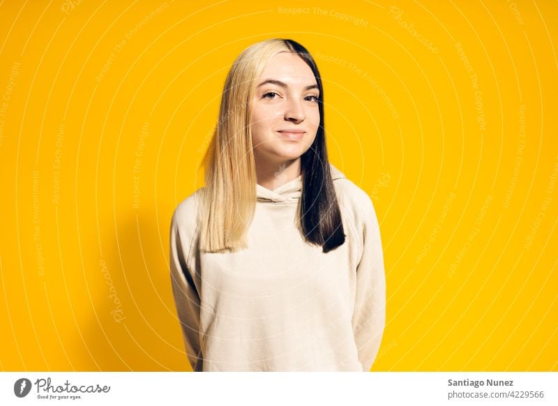 Young Girl Portrait hoodie smile smiling cute innocence cheerful happy happiness studio yellow background portrait looking at camera expression colorful