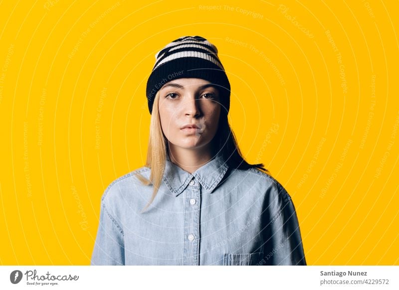 Girl Wearing Hat Portrait studio yellow background portrait looking at camera expression colorful hair style casual young girl female serious two colors hair