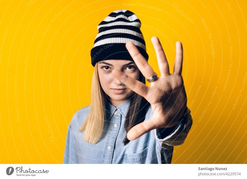 Expressive Young Girl Portrait studio yellow background portrait looking at camera expression colorful hair style casual young girl female serious