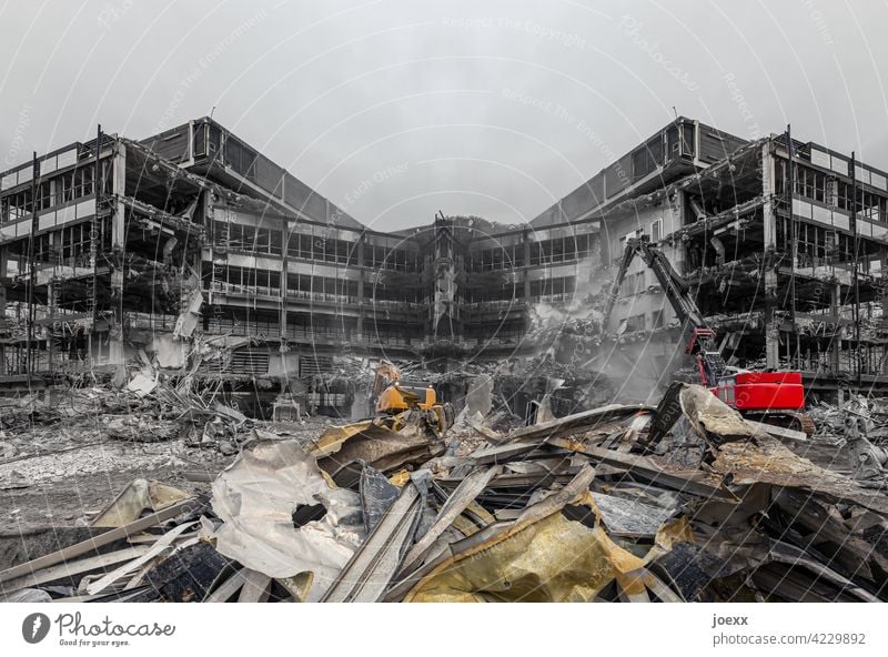 Demolition building with red and yellow excavator and scrap metal in the foreground Building Building for demolition outline Destruction Ruin Construction site