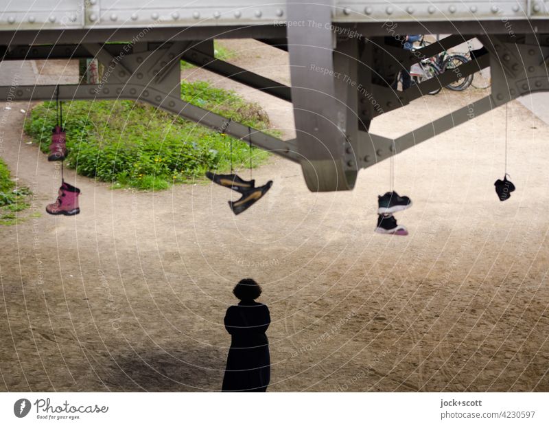 Under the bridge, don't lose your footing. shoefiti Droop In pairs Street art Footwear Bridge Silhouette Human being Prenzlauer Berg Berlin Creativity