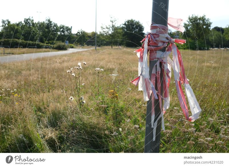 Remains of barrier tape on an event area Safety cordon flutterband corona covid-19 lockdown COVID Corona virus Risk of infection pandemic prevention Quarantine