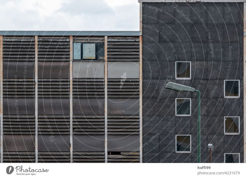 Dull old industrial facade with mirrored glass pane - construction site Construction site exposed concrete Goal nailed Facade Gloomy Gray Concrete Architecture