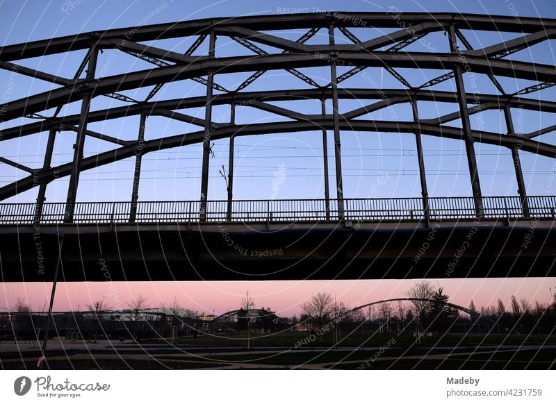 Deutschherrnbrücke with Honsellbrücke and Osthafenbrücke in the background in the light of the setting sun in the Ostend of Frankfurt am Main in Hesse