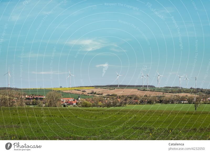 Lovely, slightly hilly landscape, with village, fields, forest and windmills on a beautiful spring day Nature Landshaft Forest Village Wind energy plant Energy