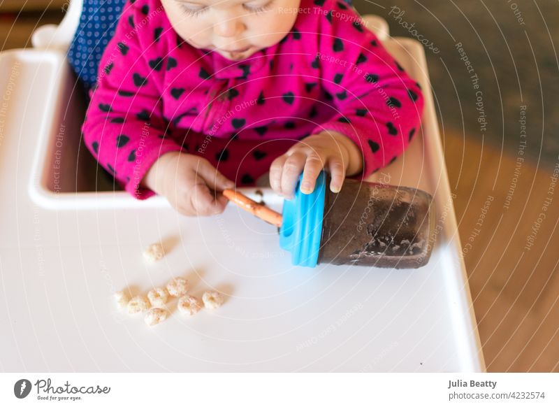 11 month old baby learning to drink out of a straw cup; berry smoothie in a glass jar with silicone straw and lid baby led weaning training toddler