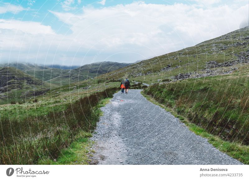 Father and daughter are enjoying staycation in Snowdonia snowdonia uk snowdonia national park track miners track rock man girl family father mount snowdon