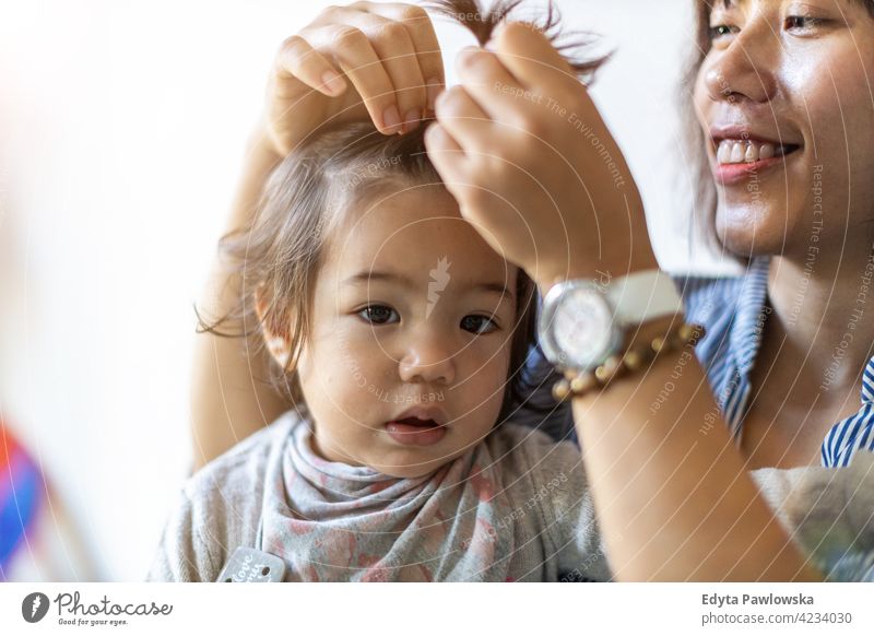 Mother and baby at home asian Vietnamese kid infant adorable beautiful child childcare childhood expression face cute little small tranquil together mother