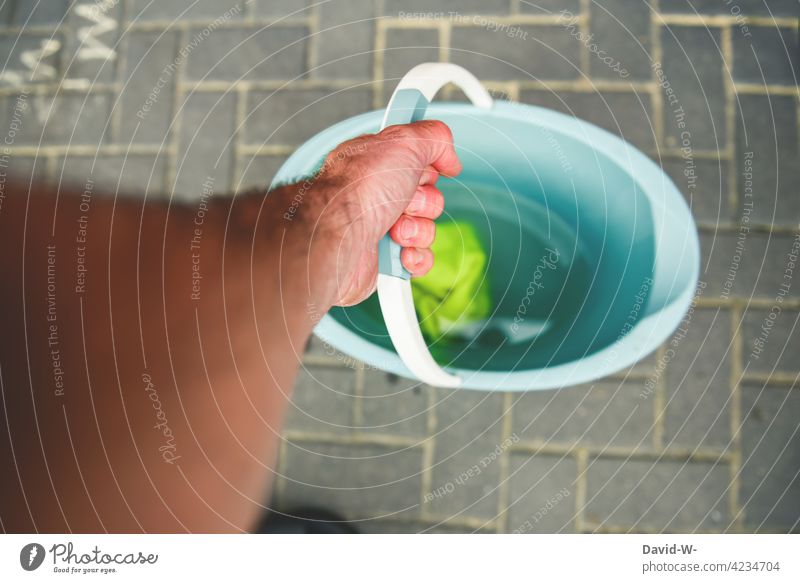 Cleaning day - hand holding a cleaning bucket cleaning day Bucket Hand stop rag cleaning rags Water do the cleaning Diligent polish