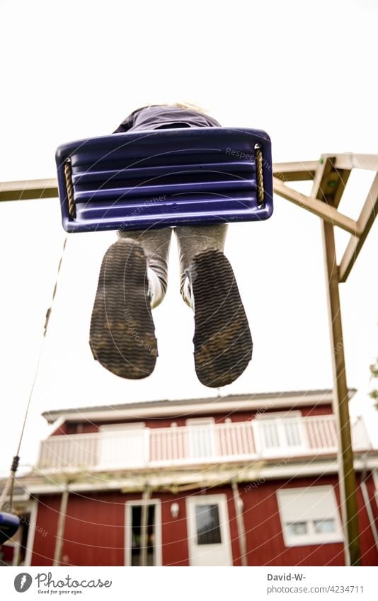 Child swinging on the swing in the garden Swing To swing Garden Playing Joy fun out Movement Joie de vivre (Vitality) Infancy Tall Happiness