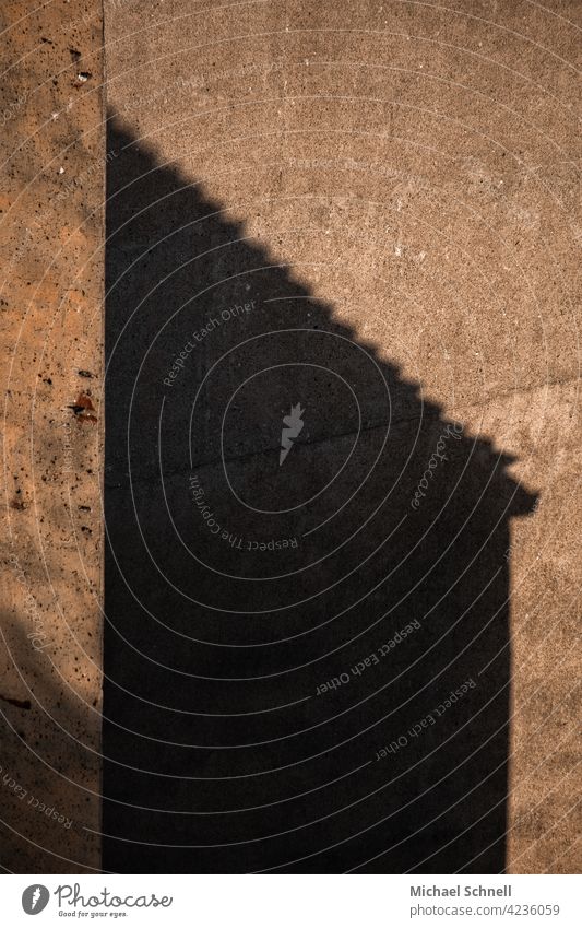 House shadow on concrete wall of a bunker Shadow Shadow play Light Exterior shot Sunlight Wall (building) Roof Roofing tile Stone Deserted Facade