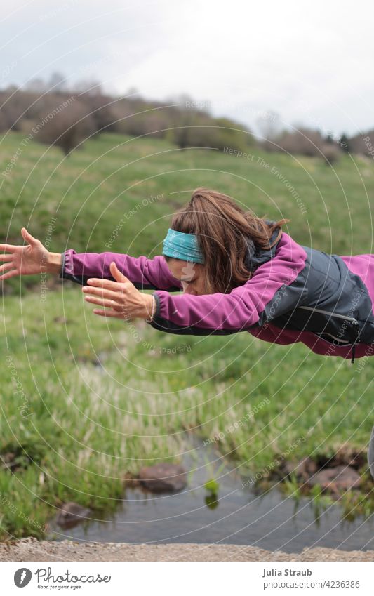 Flying through space and time Yoga Half-profile truncated long hairs Brunette Woman be out Nature Rhön Nature reserve Water bachlauf Meadow Grass Green spring