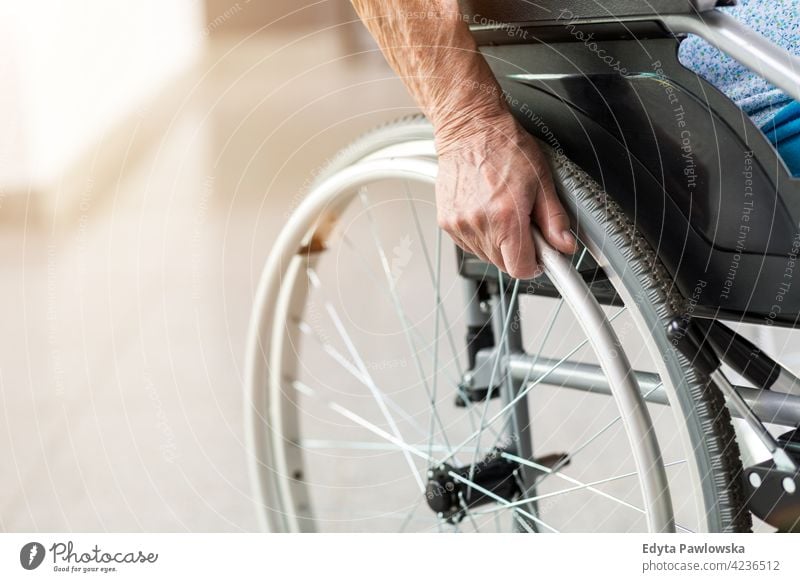 Senior person sitting in wheelchair unrecognizable person close-up hand one person loneliness lonely alone wheel chair disability physical impairment