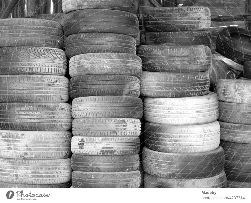 Pile of old car tires in front of a workshop in Adapazari in the province of Sakarya in Turkey, photographed in classic black and white Tire Car tire Rubber