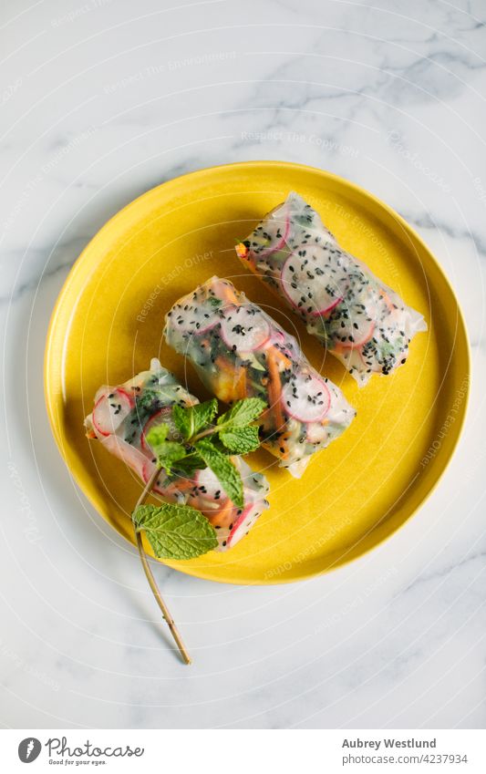 Viatnamese spring rolls with black sesame seeds, radishes, and carrots with mint garnish Asia Vietnam Vietnamese Vietnamese food appetizer asian avocado