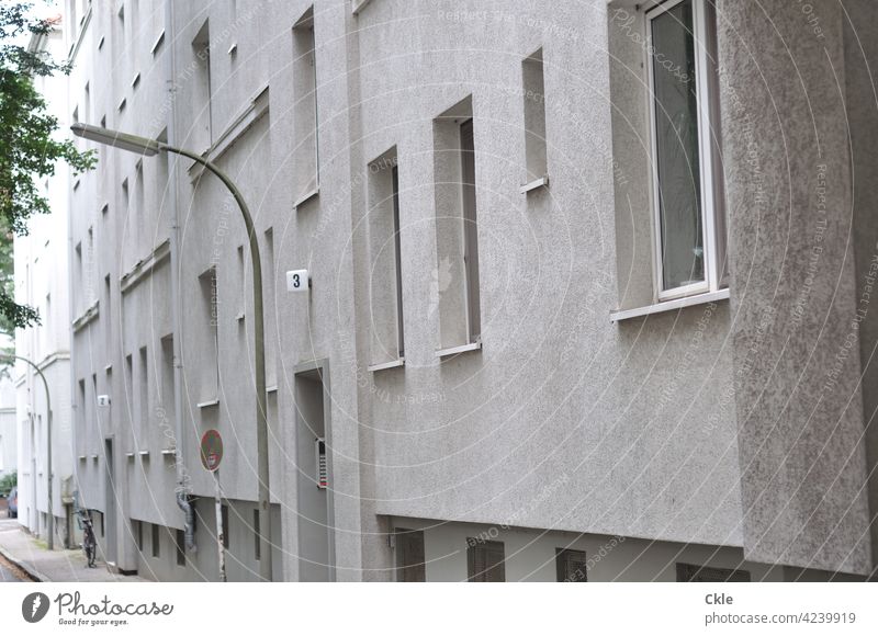 Facade of a municipal apartment building House (Residential Structure) Apartment Building Street Window doors Rent trottoir off Sidewalk street lamps Road sign