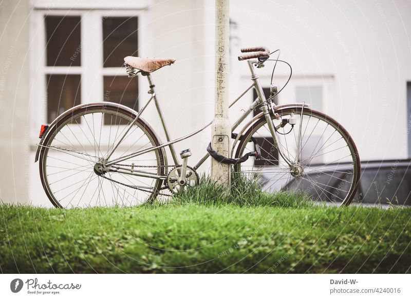 a parked locked old bicycle in a city Bicycle completed nostalgically Old Safety bicycle lock Town turned off Lantern