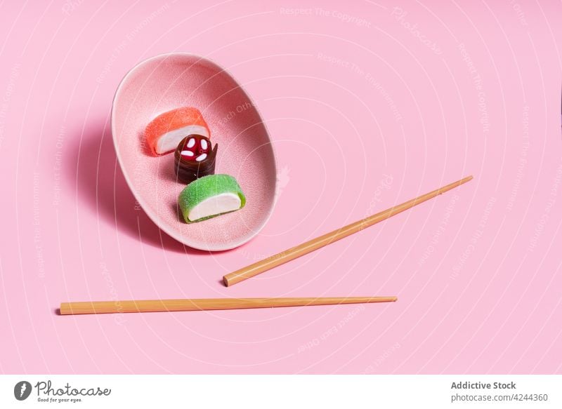 Yummy candy sushi served on pink plate with chopsticks sweet dessert asian food meal delicious yummy tradition japanese cuisine tasty gourmet dish oriental