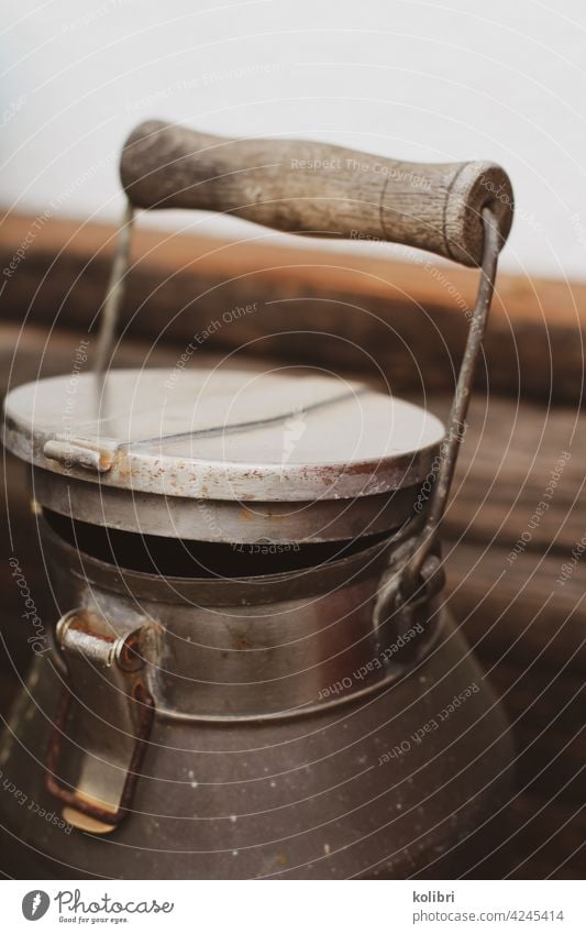 Old milk jug with lid and wooden handle Milk churn Antique can Decoration Ancient Shabby Chic decoration vintage Rustic Retro Tradition Detail Metal Wood Design