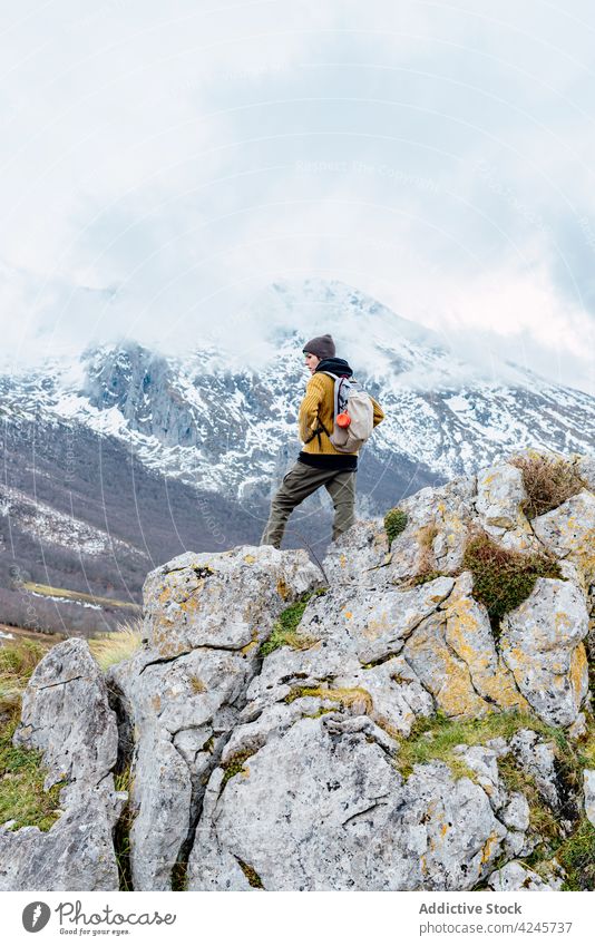 Tourist with backpack on mountain cliff traveler ridge adventure trekking nature wanderlust freedom hiker highland peak valley achieve height explorer tourist