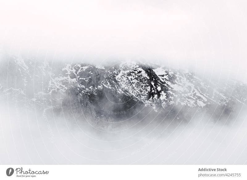 Hazy snowy ridge of wild mountains fog invisible haze dark dramatic mist nature range peak landscape valley cold harmony remote peaks of europe picos de europa